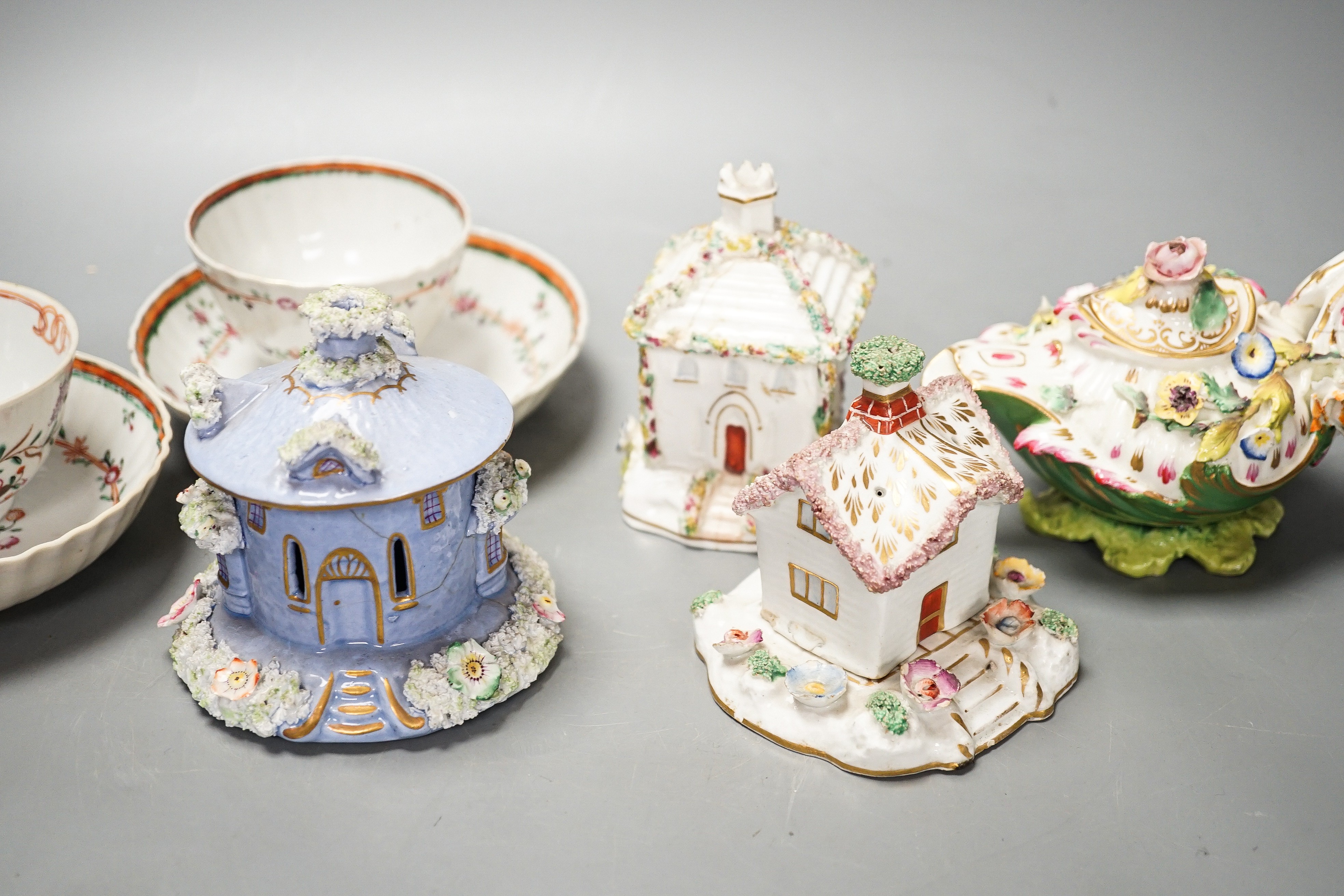 Three Chinese export famille rose tea bowls and two saucers, three Staffordshire porcelain cottage pastille burners and an English porcelain cream boat